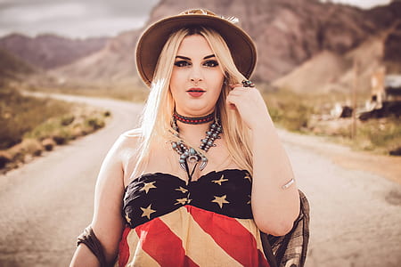 woman wearing USA flag print jewel-neck top and black hat thumbnail
