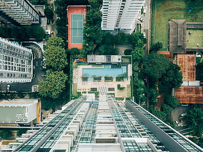 aerial photography of gray concrete building surrounded with green grass thumbnail