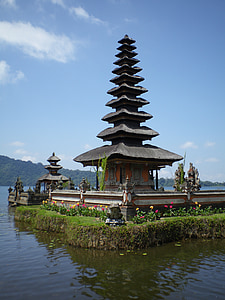 gray pagoda surrounded with body of water thumbnail