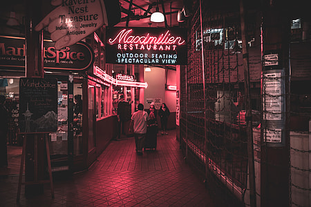 man walking between stores with pink lights thumbnail