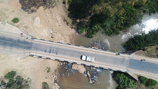 aerial photography of white vehicle on road at daytime thumbnail