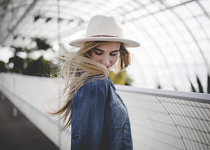 woman standing near gate watching her ahir thumbnail