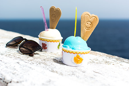 two ice creams beside black framed sunglasses thumbnail