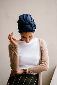 Woman Wearing Blue Turban, White Top and Brown Cardigan thumbnail