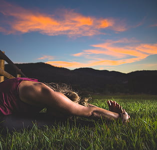person lying on grass field thumbnail