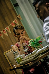 man and woman sitting on dining area while talking thumbnail