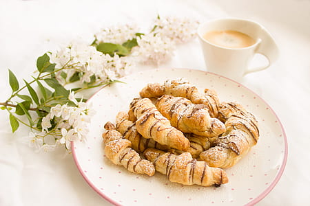 breads on top of white ceramic plate beside coffee mug thumbnail