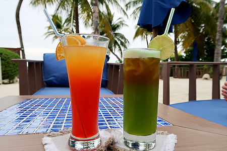 two filled clear highball glasses on table thumbnail