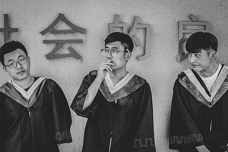 greyscale photography of three men in academic robes thumbnail