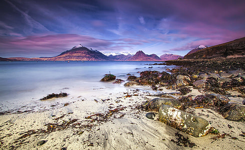 calm sea under blue and purple sky thumbnail