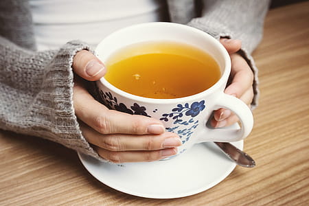 Female hands holding hot cup of tea thumbnail