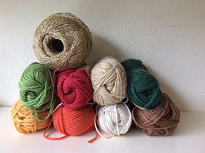 assorted-color yarn lot on top of white surface thumbnail