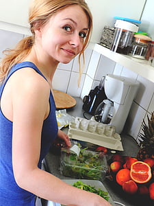 woman wearing blue tank top holding white plastic container thumbnail