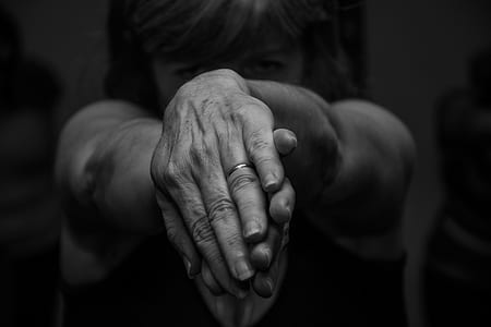 grayscale photography of woman twisting both hands thumbnail