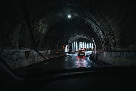 photography of vehicle crossing tunnel at daytime thumbnail