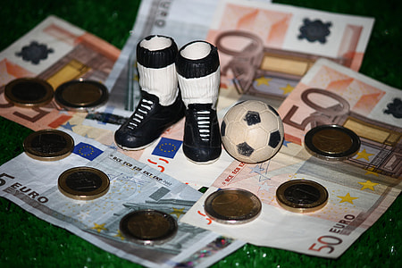 white-and-black boots beside soccer ball miniature thumbnail