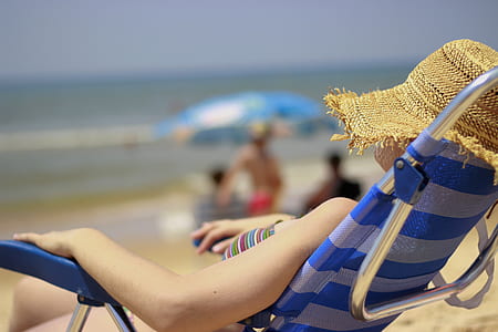 woman sitting on lounger chair during daytime thumbnail