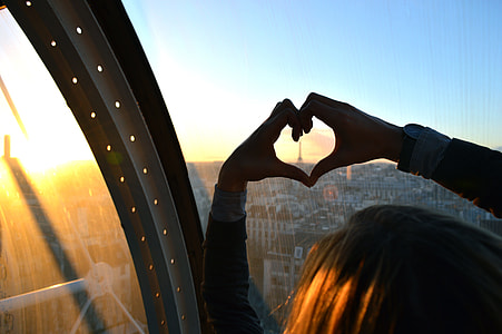 person showing hands forming heart shape thumbnail