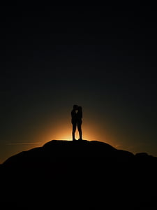silhouette of couple on top of a hill thumbnail