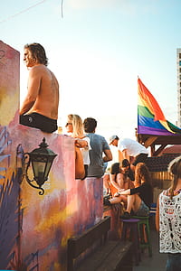 group of teenagers sitting on concrete wall thumbnail