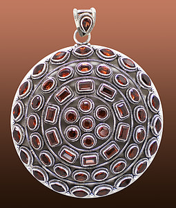 close up photo on round silver and brown gemstone pendant thumbnail