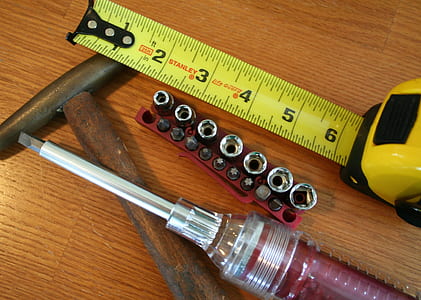 assorted-color tools on brown wooden table thumbnail