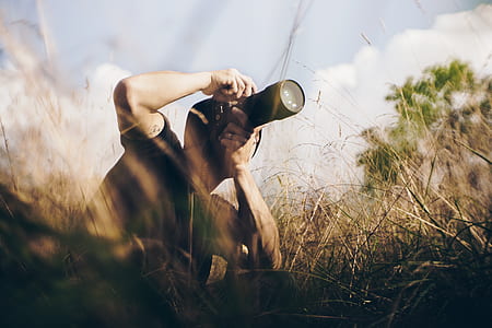 person taking photos while docking on grass field thumbnail
