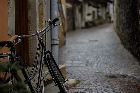 shallow focus photography of black cruiser bicycle in streetwalk thumbnail