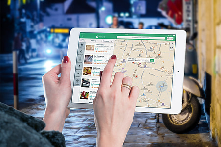 person's index finger pointing GPS map screen display thumbnail