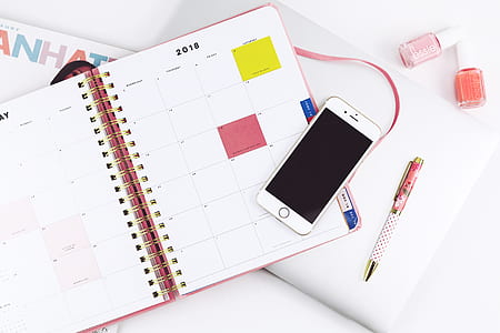 flat lay photography of turned off iPhone on 2018 planner thumbnail