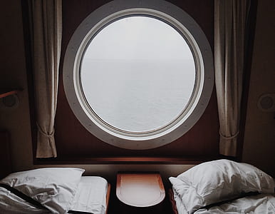 round white wooden window pane between of window curtains thumbnail