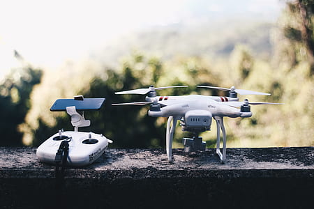 shallow focus photography of drone with remote thumbnail