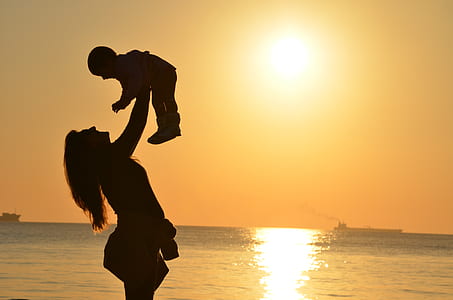 silhouette of woman carrying baby thumbnail