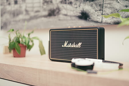 shallow focus photography black Marshall speaker on wooden board thumbnail
