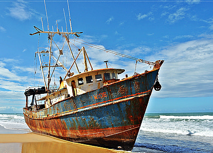 blue and white ship lands on seashore thumbnail