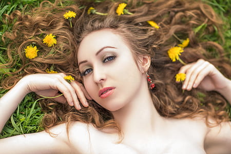 woman lying down on green grass thumbnail