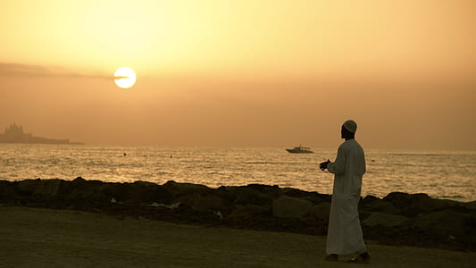 man walking in seashore thumbnail