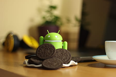 Android toy beside oreo cookies on table thumbnail