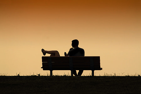 woman lying on man's lap sitting on bench thumbnail