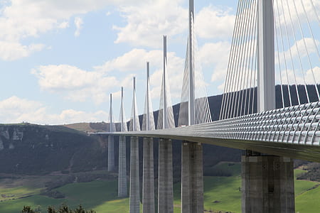 white steel and concrete bridge in landscape photography thumbnail