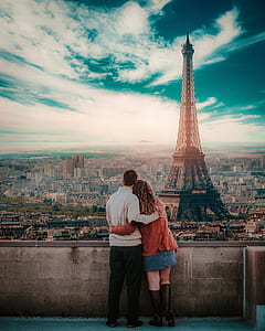 coupe standing outside the building in front of Eiffel Tower, Paris thumbnail