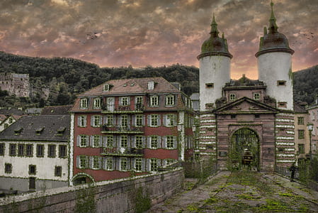landscape photography of vintage concrete houses under orange sky thumbnail