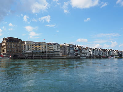 brown concrete buildings near sea thumbnail