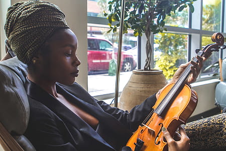 Woman Holding Violin by the Window thumbnail