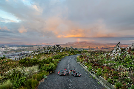 black bicycle on gray concrete road near green grass thumbnail