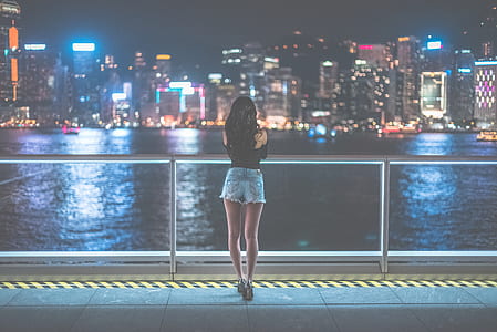 Woman Watching View of Metropolis during Nighttime thumbnail