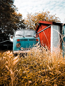classic blue Volkswagen T1 van near white and red wooden house during daytime thumbnail