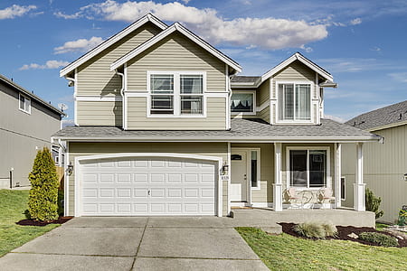 white wooden house with driveway thumbnail