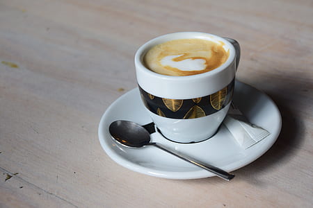 white and black espresso cup and saucer with teaspoon thumbnail