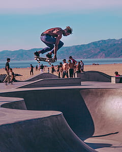 man skating on skate park near the body of water during daytime thumbnail